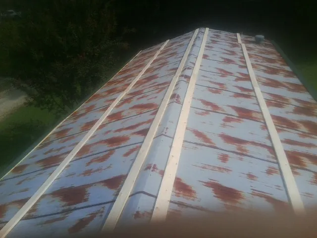 Rusted metal roof panels with new wood purlins before replacement — Storm Damage Roof Repair in Monroeville by Roofing Brothers